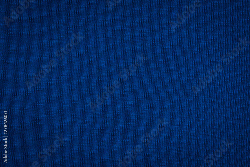 Texture of real dark blue knitwear, textile background.