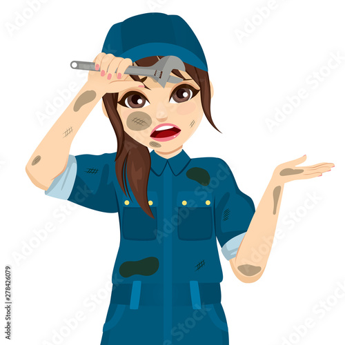 Dirty tired exhausted female auto mechanic with grease stains holding monkey wrench tool