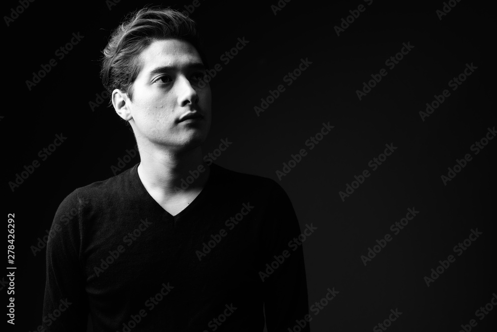Young multi-ethnic handsome man in black and white Young multi-ethnic handsome man in black and white
