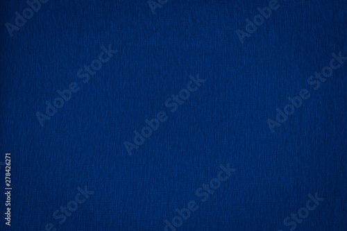 Texture of real dark blue knitwear, textile background.