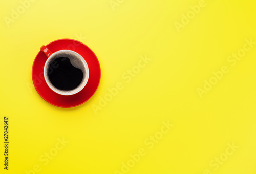 Red coffee cup over yellow background