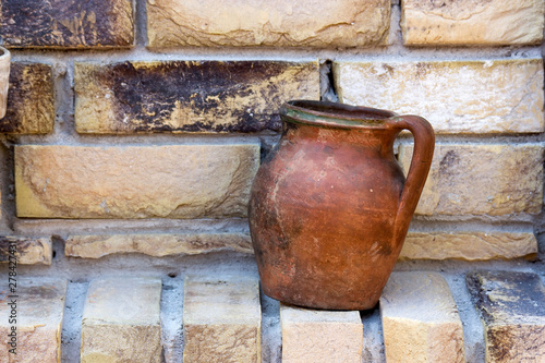 clay pot on a brick wall