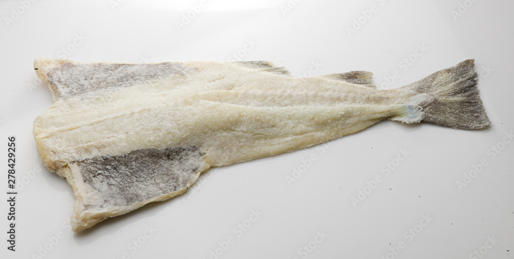 bacalao salado, pieza entera sobre fondo blanco. salted cod, whole piece on white background.