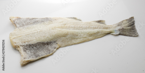 bacalao salado, pieza entera sobre fondo blanco. salted cod, whole piece on white background. photo