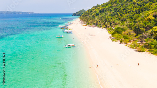 Puka Shell Beach, Boracay Island, Philippines, aerial view. Tropical white sand beach and beautiful lagoon. Tourist boats and people on the beach. People relax on the beautiful coast. © Tatiana Nurieva