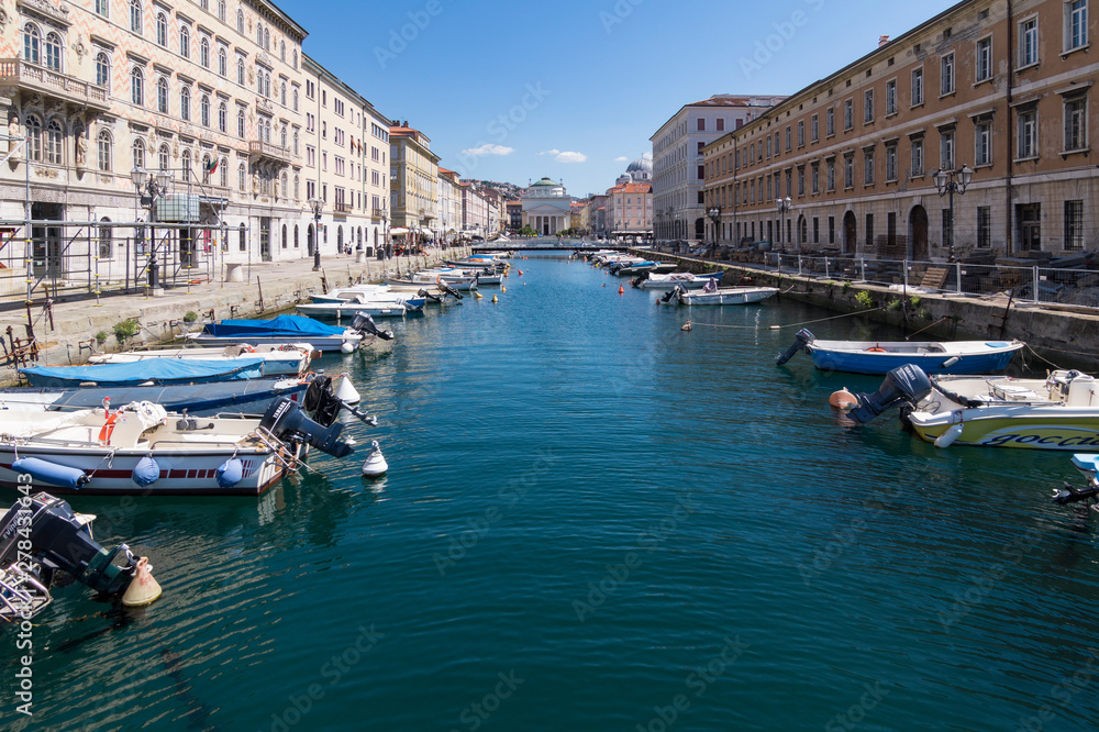 Views of the Grand Canal of Trieste, with the Church of San Antonio Nuovo in the background and the boats bordering the canal, Italy