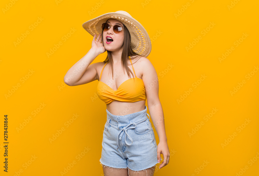 Young caucasian woman wearing a straw hat, summer look trying to listening a gossip. Young caucasian woman wearing a straw hat, summer look trying to listening a gossip.