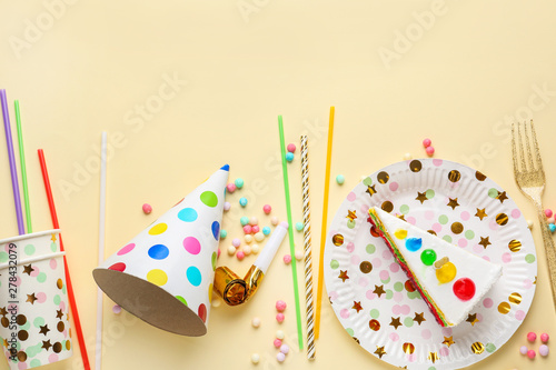 Party decor with Birthday cake on color background