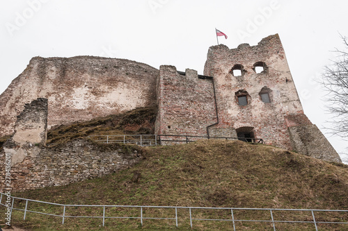 Ruins of the brick walls of Czorsztyn Castle and itts reflecion on a rainy and foggy day. Ruins stand at the top of the hill nearby Dunajec River in he southernmost part of Poland. photo