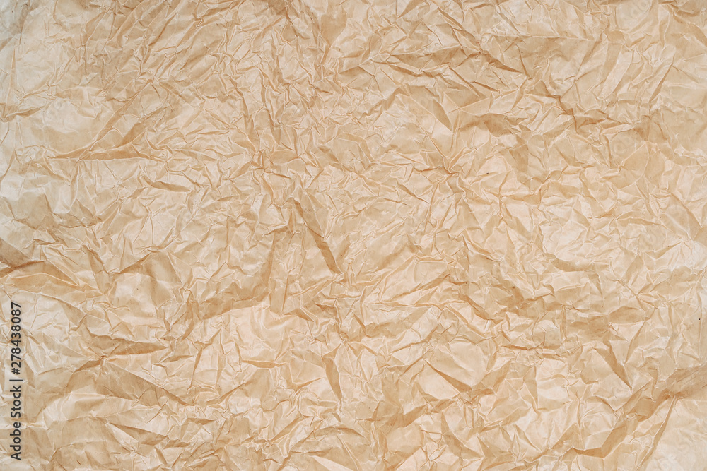 Texture of crumpled parchment paper. Background of creased brown backing paper. Crumpled paper texture. Texture of crumpled parchment paper. Background of creased brown backing paper. Crumpled paper texture.