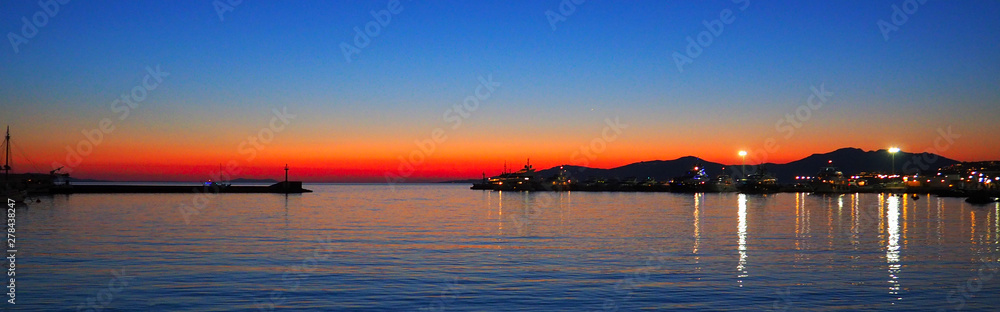Amazing sunset over the port of Mykonos, beautiful Cycladic island in the heart of the Aegean Sea