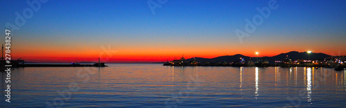 Amazing sunset over the port of Mykonos, beautiful Cycladic island in the heart of the Aegean Sea © Mariedofra