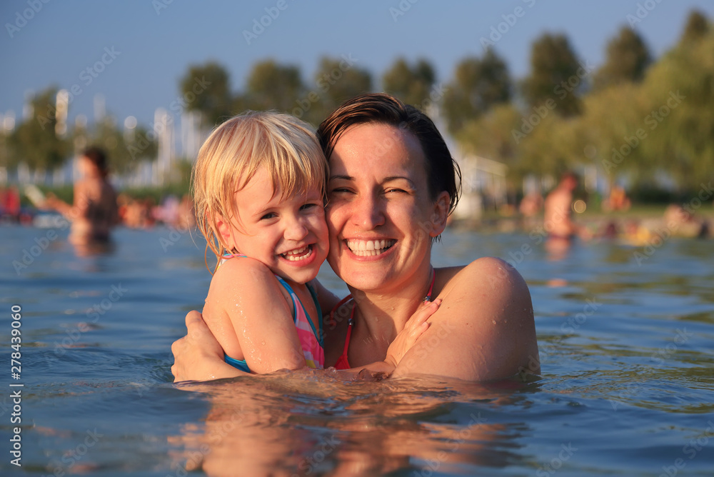 Fototapeta premium Mother with her cute child in water