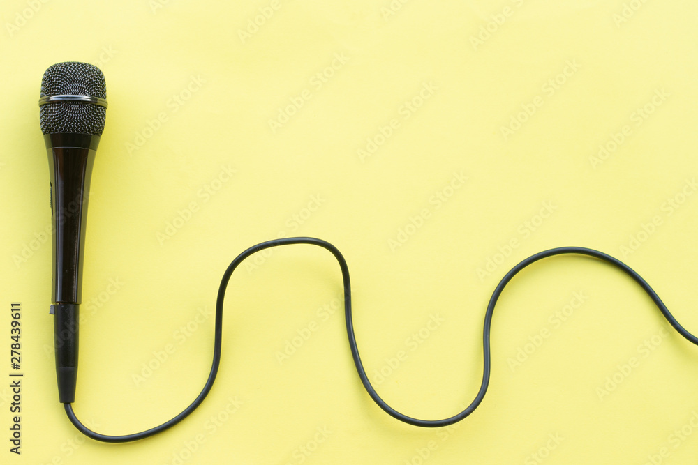 microphone for blogger, journalist or musician work on yellow background. karaoke microphone. top view mock up top view space for text microphone for blogger, journalist or musician work on yellow background. karaoke microphone. top view mock up top view space for text