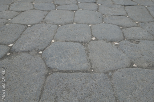 White reflective stones can be seen in a patterned roman road used to light the route at night time.First man made cats eyes - Image