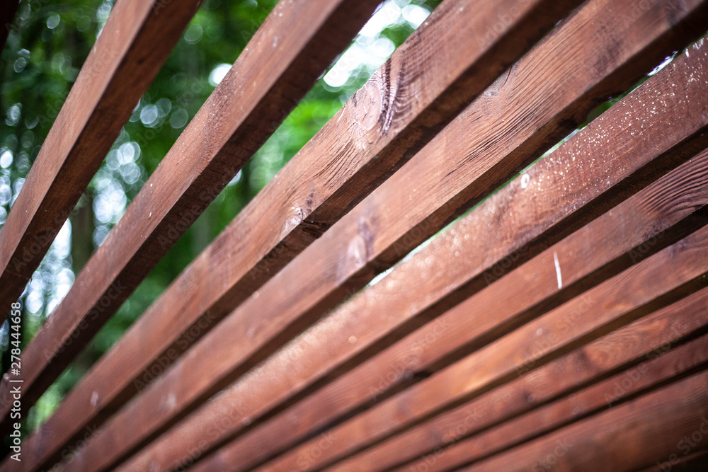Wooden slats for the construction of a veranda. Simple wooden construction. Boards painted in shorter. Wood texture. Wooden slats for the construction of a veranda. Simple wooden construction. Boards painted in shorter. Wood texture.