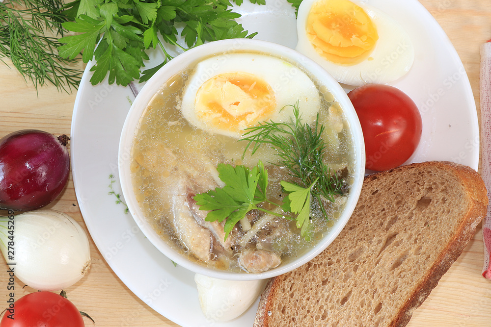 Traditional Russian soup with egg and bread on a wooden table. Delicious traditional natural food and cooking ingredients, healthy diet concept, Traditional Russian soup with egg and bread on a wooden table. Delicious traditional natural food and cooking ingredients, healthy diet concept,