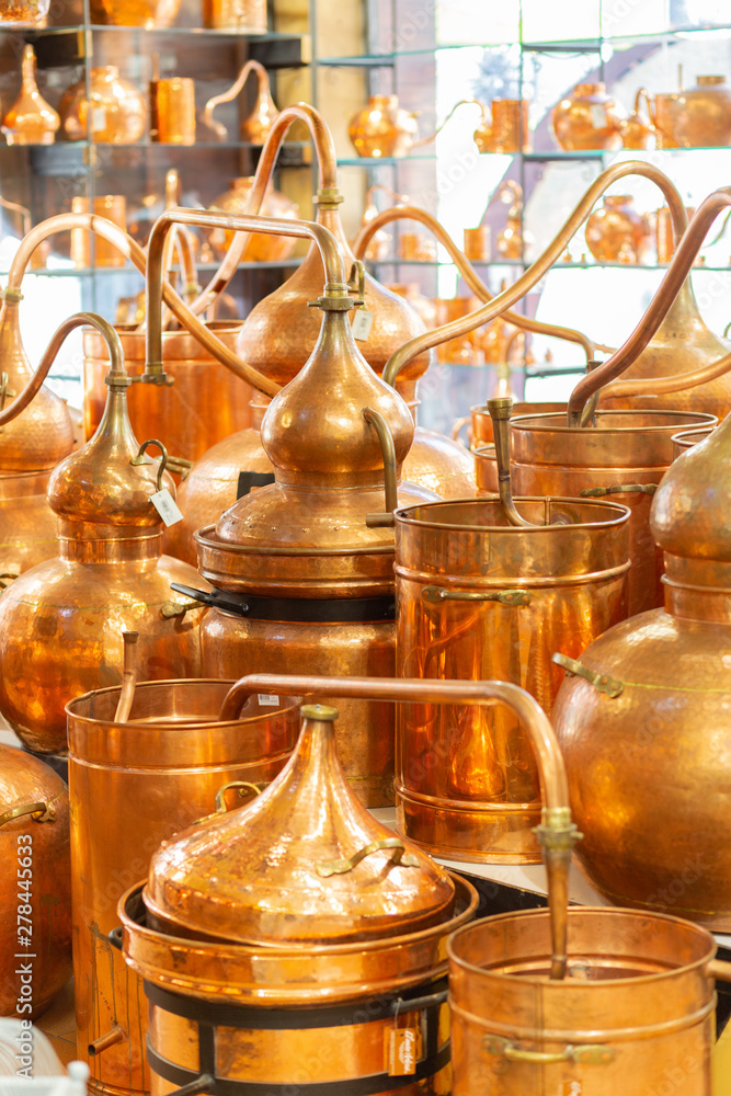 Copper ware, serpentine and jugs on the shop window in the store. Copper ware, serpentine and jugs on the shop window in the store.