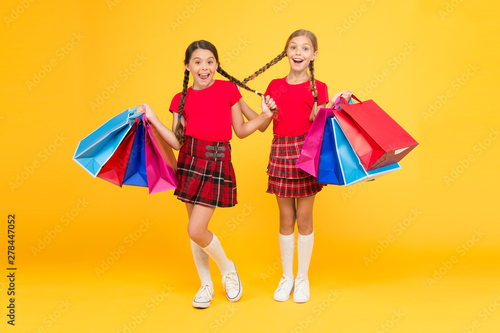Pleasant shopping. purchase. black friday. holiday presents. Sale and discount. girls shopping. happy children with shopping bags. successful shopping. big sales. school girls with packages