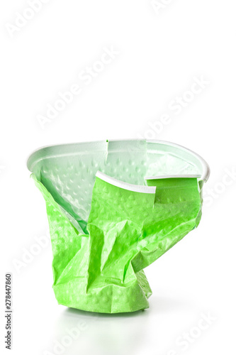Green crumpled plastic cup isolated on white background