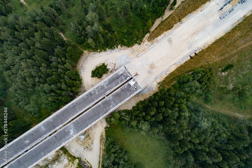 Drone aerial view on road and viaduct in construction. - obrazy, fototapety, plakaty 