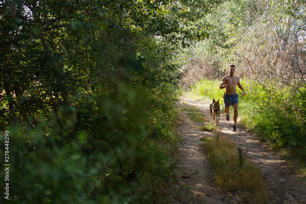 runner running across the field with his dog