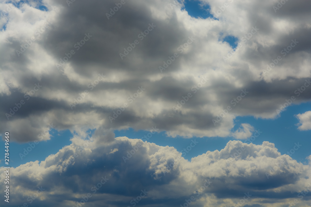 several cumulus clouds over blue sky