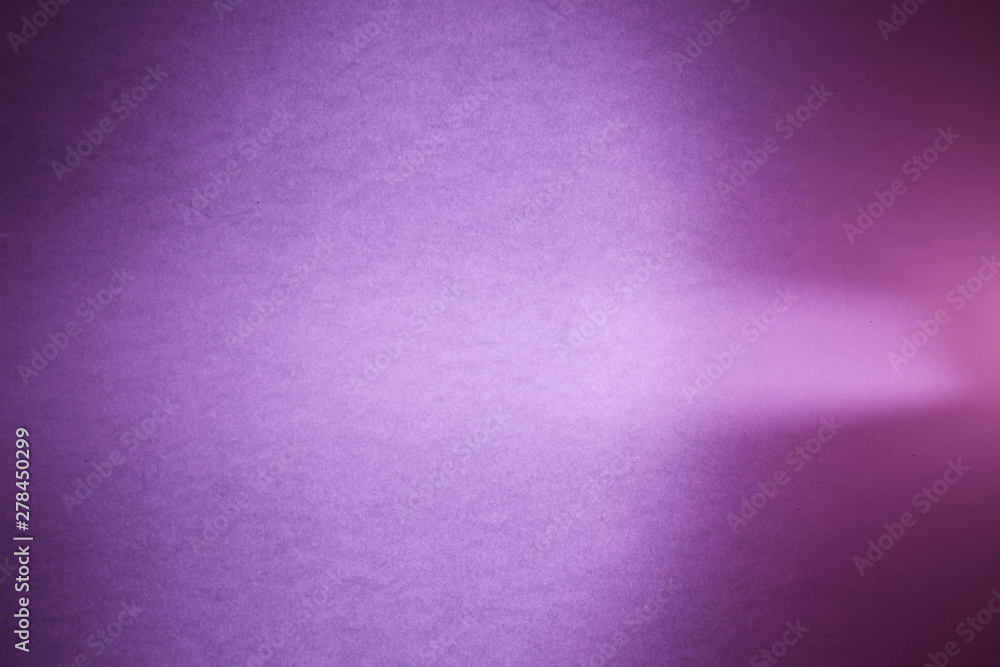 Light purple ray of light in the middle of a purple textural and floor blurred background Light purple ray of light in the middle of a purple textural and floor blurred background