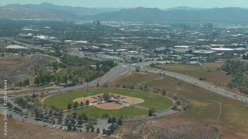 Aerial the city of Reno from a hill looking over baseball fields. Nevada, USA Aerial the city of Reno from a hill looking over baseball fields. Nevada, USA