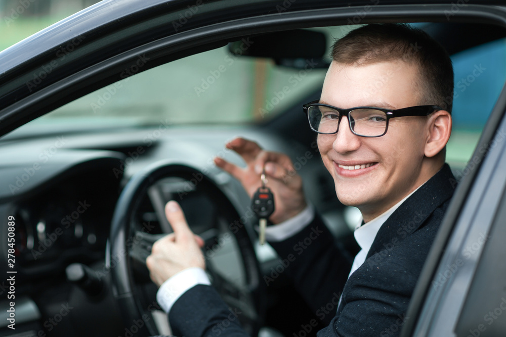 happy businessman showing the key of his new car. happy businessman showing the key of his new car.