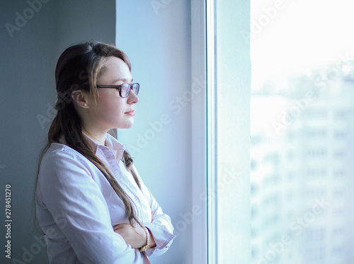 Executive business woman looking out the office window