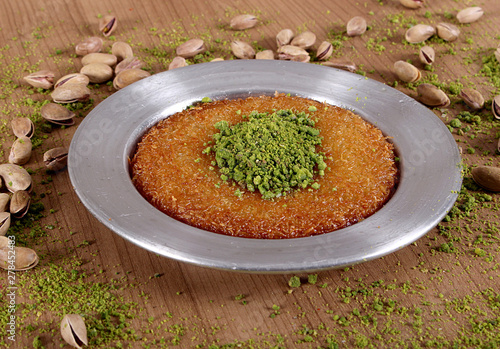 the best turkish baklava kunefe fresh on the plate is filled with green pistachio powder