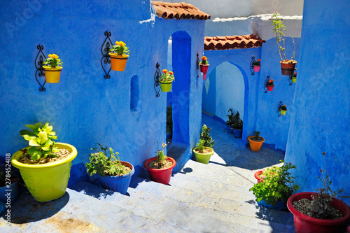 Typical beautiful moroccan architecture in Chefchaouen blue city medina in Morocco with blue walls © Andrii Vergeles
