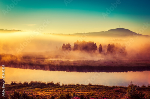 Sunrise over spring meadow. Spring aerial landscape. Spring sunrise over green forest and field with river and fog © vladimircaribb