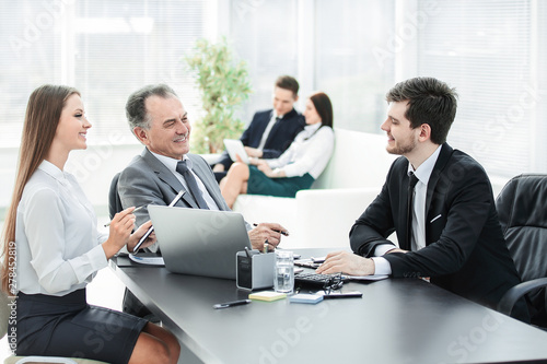 client talking with the staff at the Desk in the office
