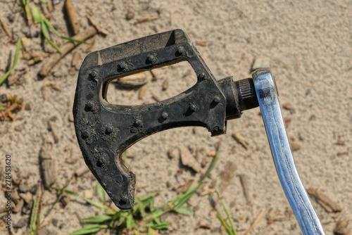 Fototapeta Naklejka Na Ścianę i Meble -  old broken pedal of black plastic and gray metal on a bicycle