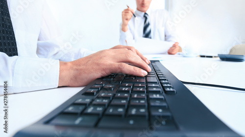 close up.modern businessman typing on a laptop