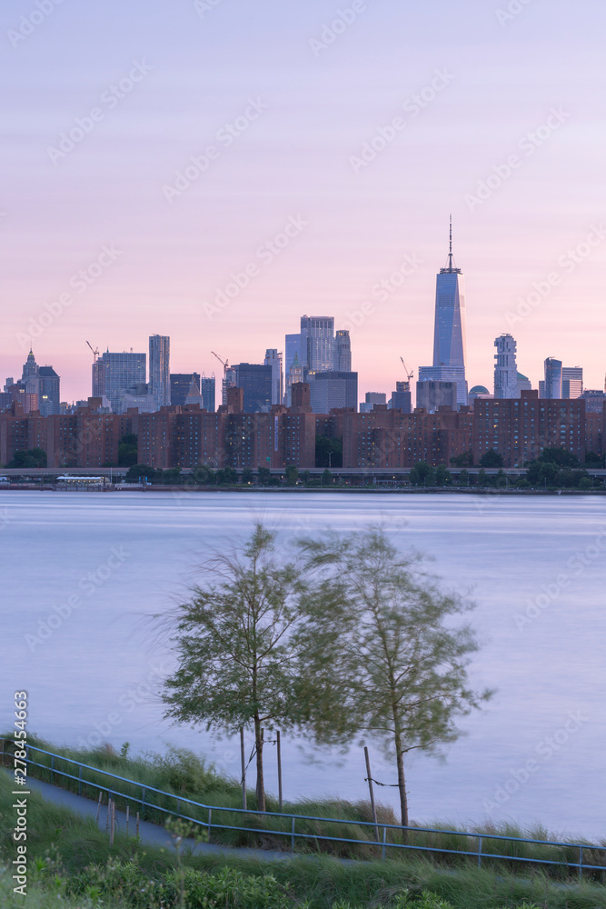 Fototapeta premium Long Island Pier at sunset and Downtown Manhattan on background,long exposure.