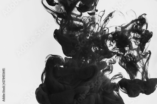 Black paint in water isolated on white background 