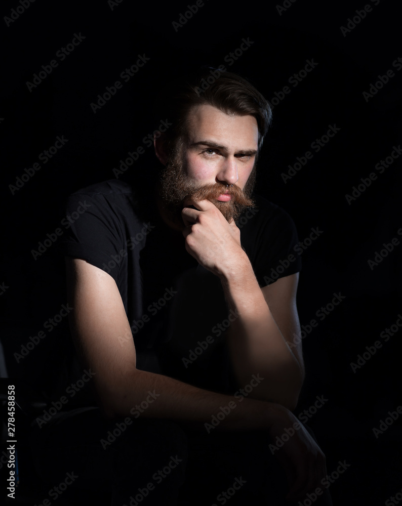 serious hipster man sitting in a chair. serious hipster man sitting in a chair.