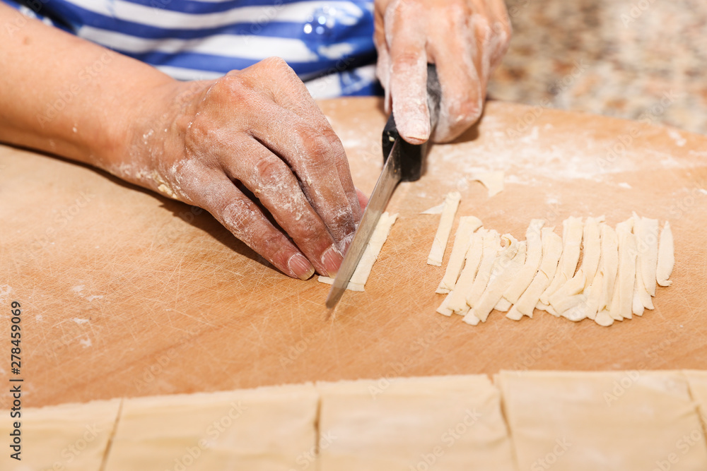 Side view woman's hands make Turkish Ravioli on table. Plates of traditional Turkish food. manti Side view woman's hands make Turkish Ravioli on table. Plates of traditional Turkish food. manti