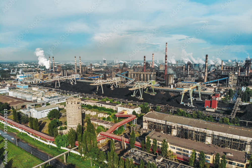 Large industrial zone of heavy metallurgical industry aerial view, lot of factories with pipes, smokestacks and smoke