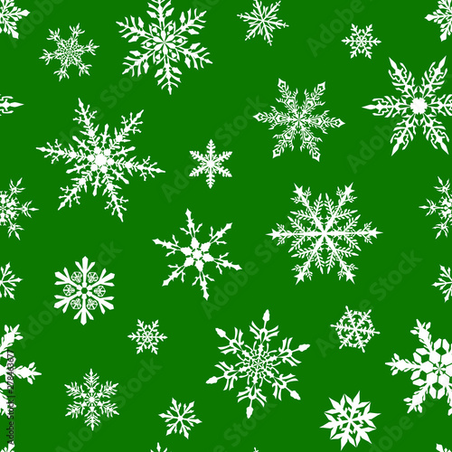 Christmas seamless pattern of complex big and small snowflakes in white colors on green background