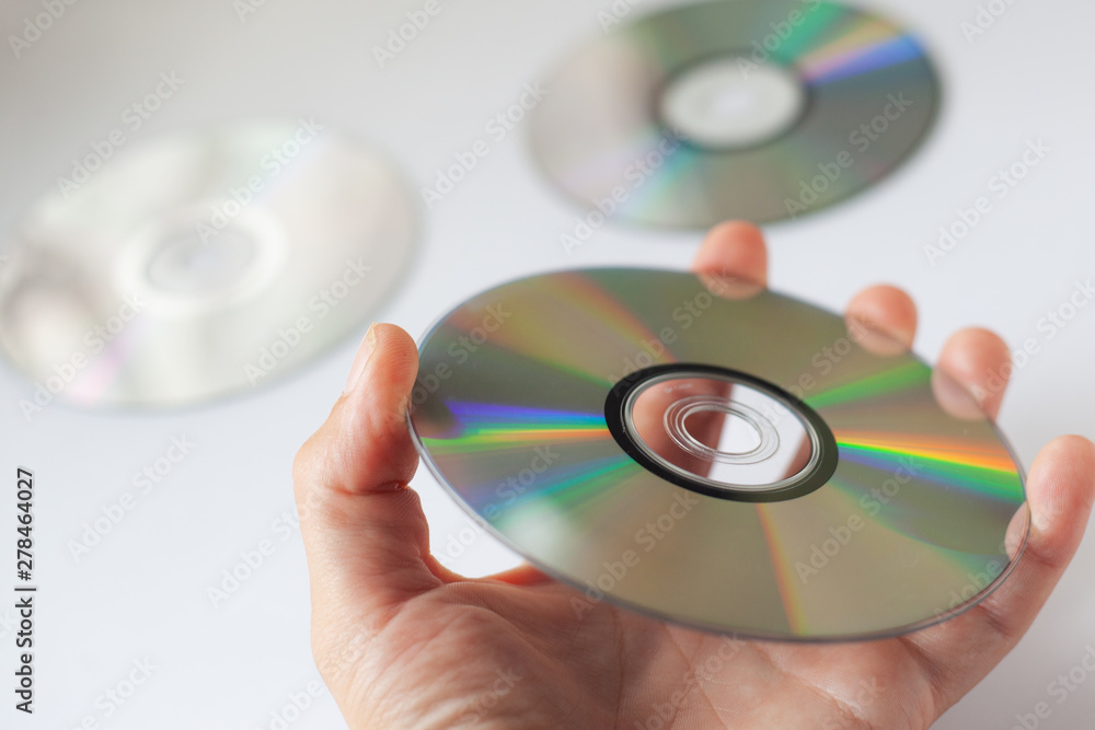 cd compact disc in the hand on white background cd compact disc in the hand on white background