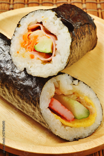 Seafood hand roll sushi on wooden plate