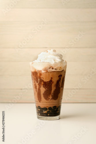 Quadro em tela Ice coffee in the glass topped whipping cream with coffee beans