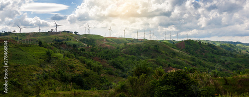 Panorama view of Clean energy generator electric system of Wind turbines on top mountain with sunny in morning time and cloud in Khao kho, Phetchabun province, Thailand photo