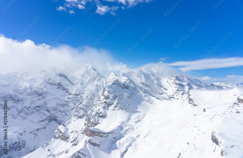 Stunning panoramic view of the Swiss Alps from the top of the Schilthorn mountain in the Jungfrau region of the country