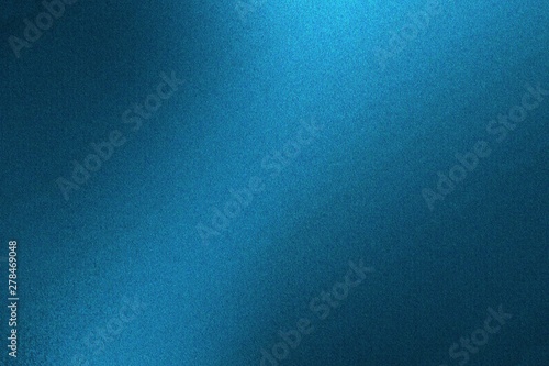 Light shining on blue metallic wall in dark room, abstract texture background