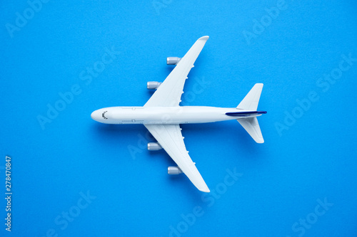 Model commercial airplane on blue pastel color background